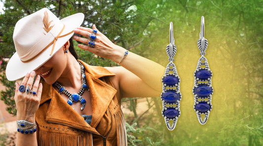 American West Jewelry sterling silver lapis lazuli three-stone drop earrings alongside a woman wearing lapis squash blossom necklace, rings, and bracelet styled in a Western suede vest, celebrating September's blue birthstone